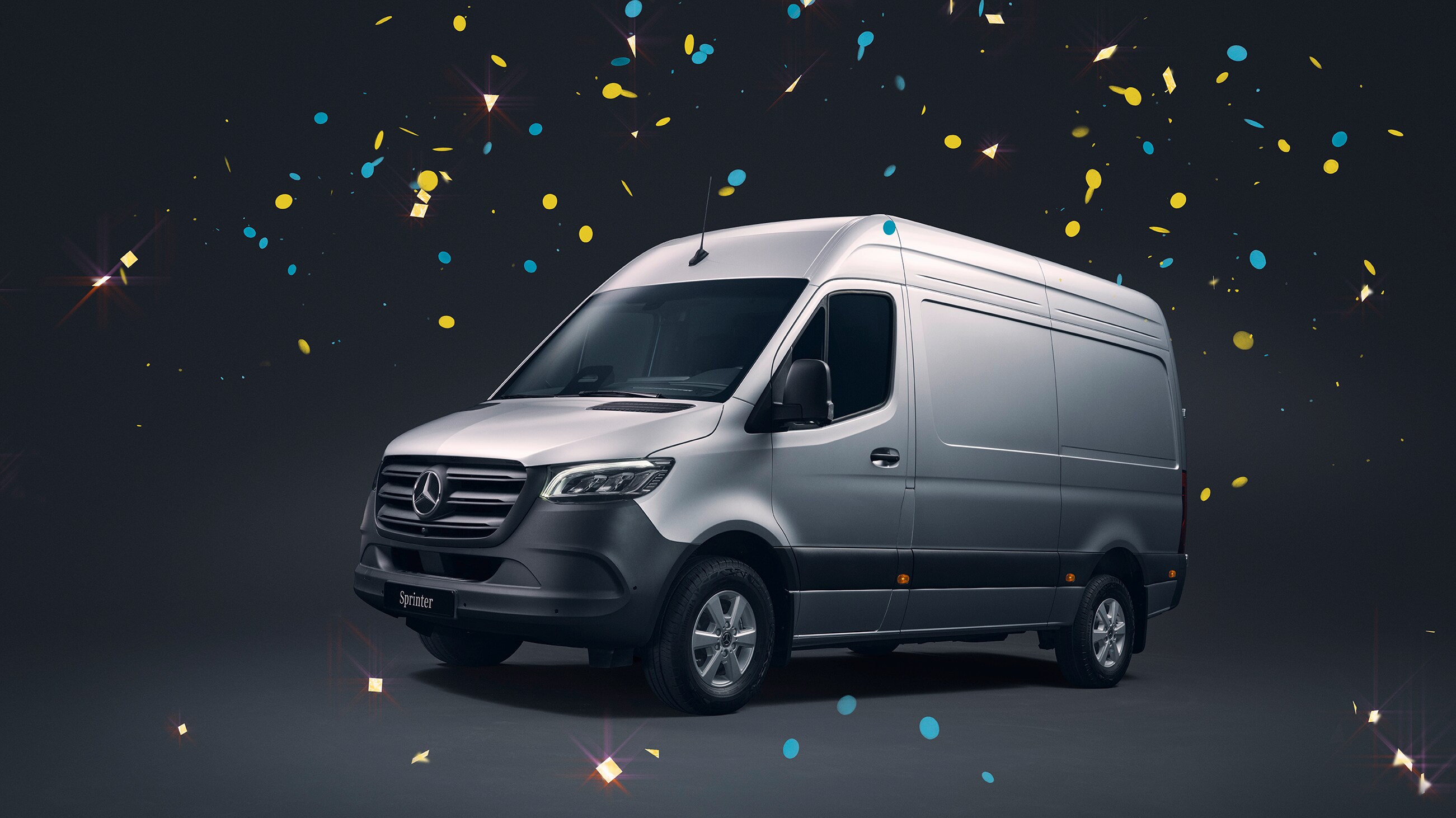 The Mercedes-Benz eSprinter, eCitan and eVito are lined up on display, with the eVito docked at a charging station.