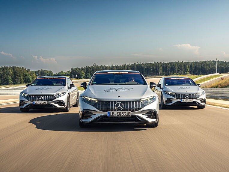 Front view of three Mercedes-AMG vehicles out and about on the road.