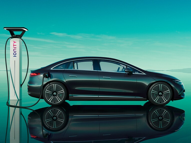 The EQE Saloon from Mercedes-Benz charging at a public charging station.