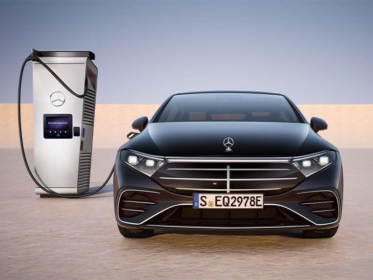 Front view of the EQS Saloon from Mercedes-Benz, charging at a public charging station.