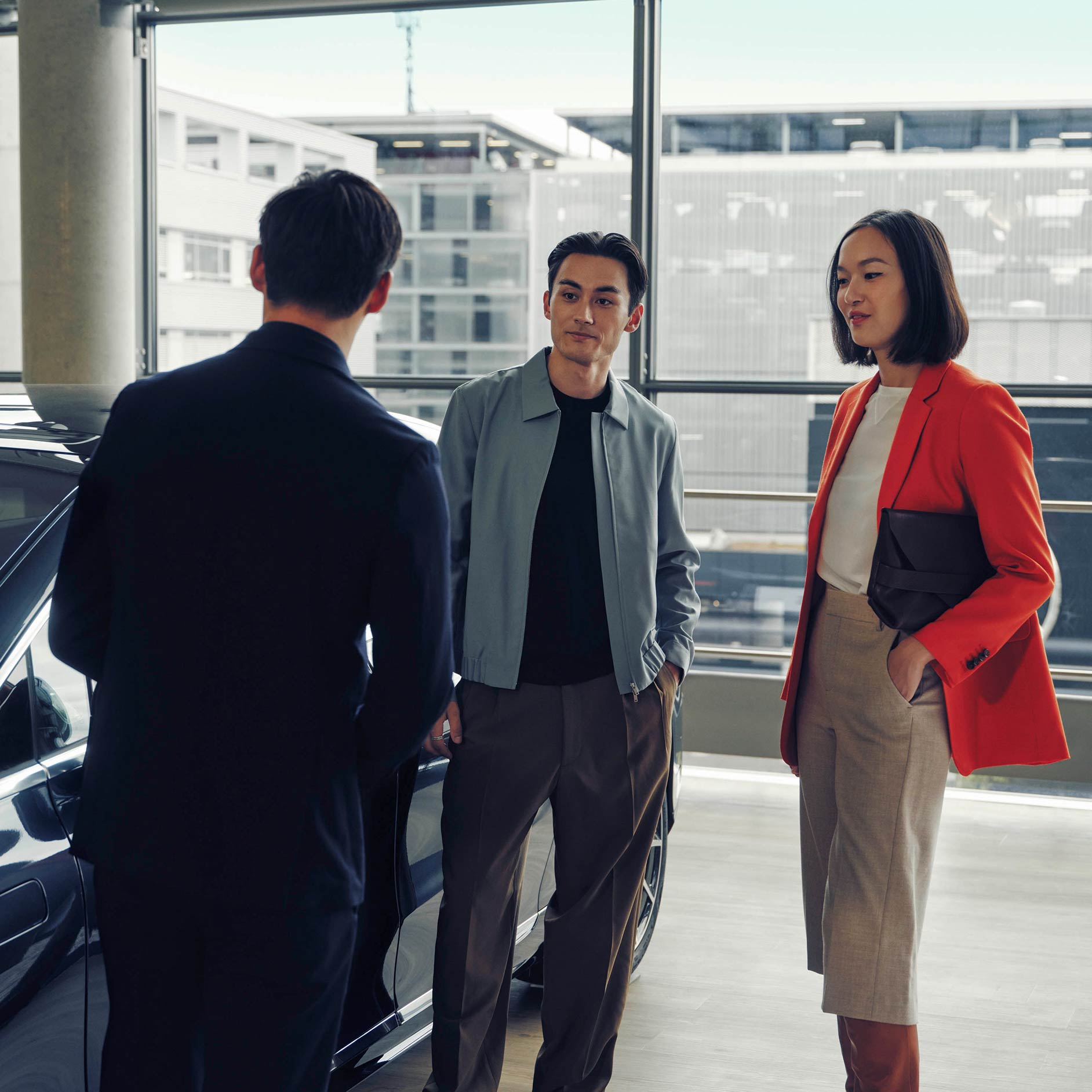 Man and woman previewing the car with sales consultant Agility | Offers | Financial Services | Leasing & Financing | Mercedes-Benz