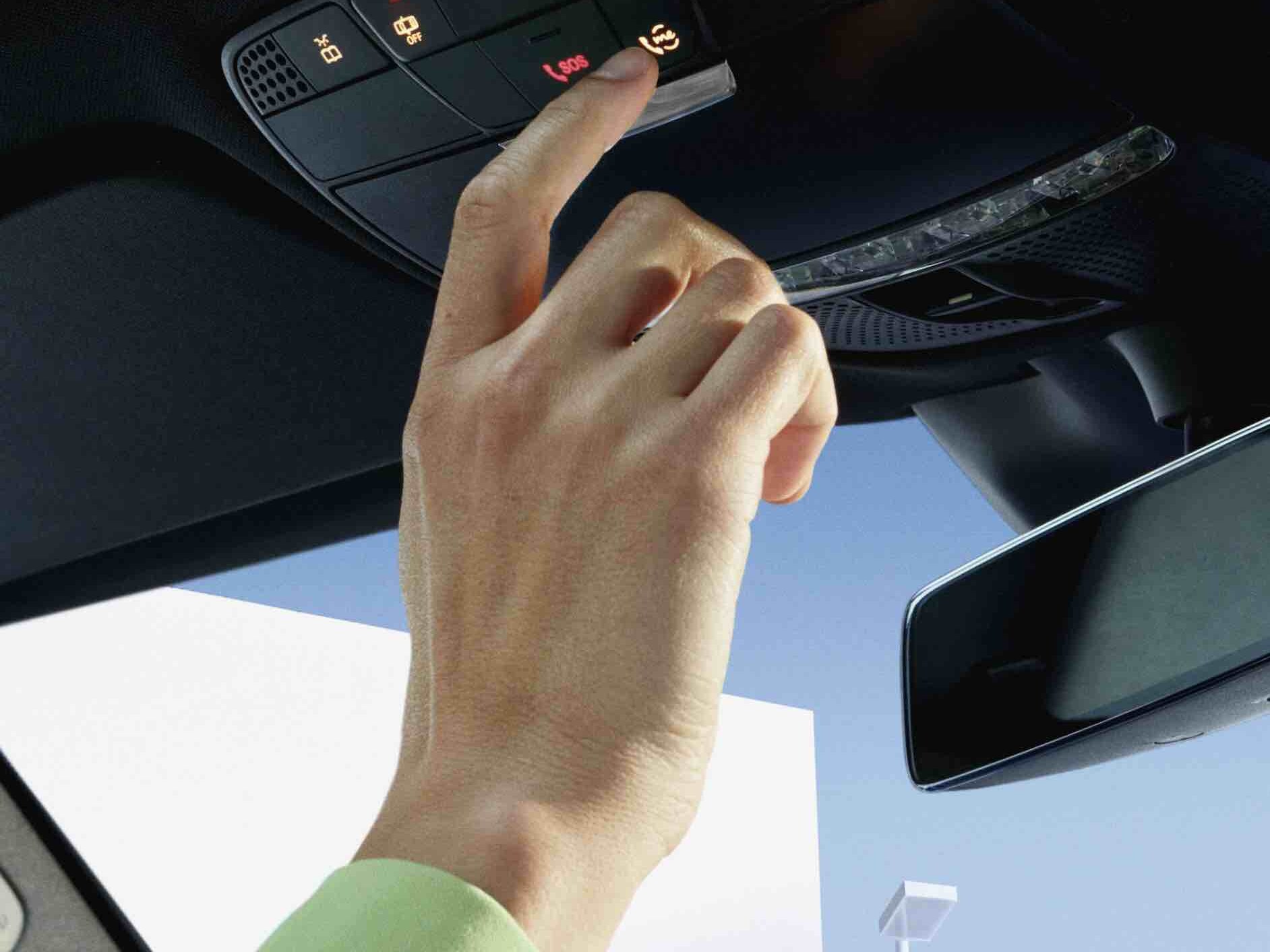 Person pressing the Mercedes me button in the control panel