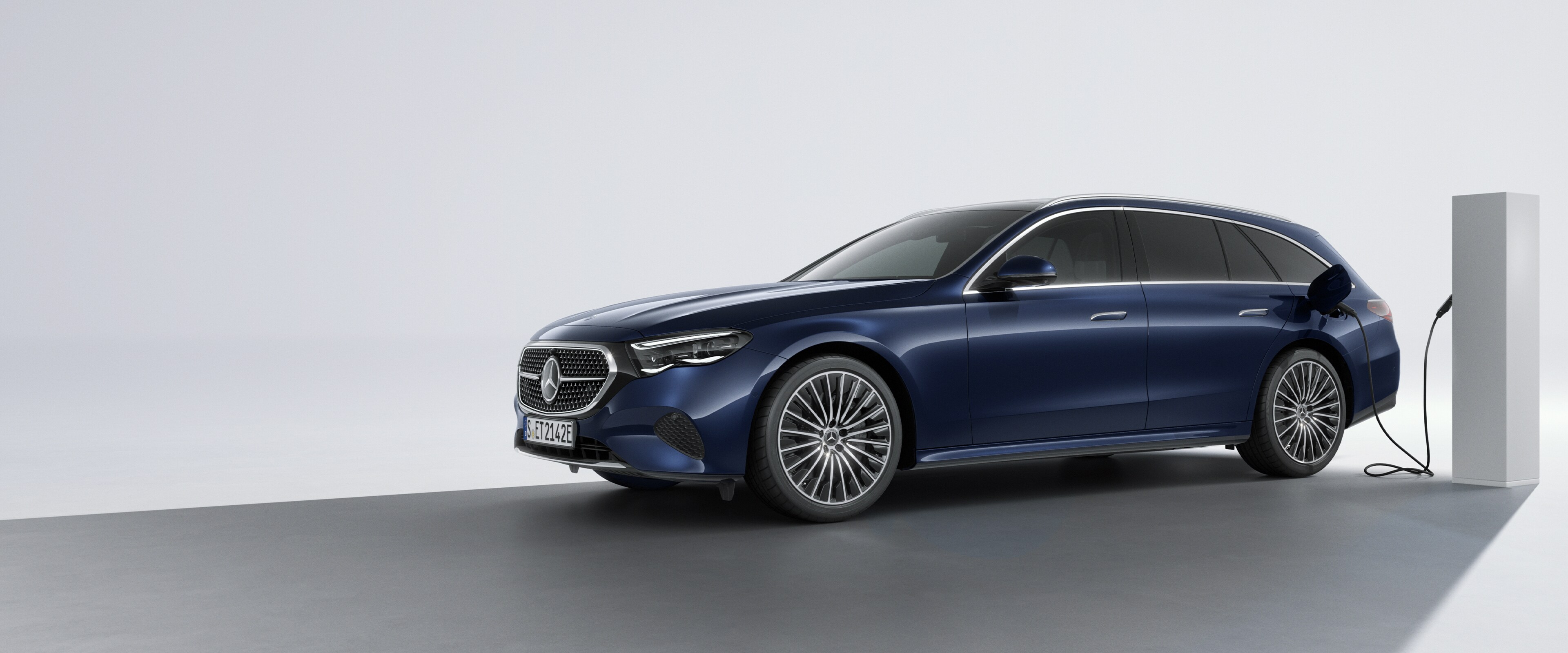 A plug-in hybrid vehicle from Mercedes-Benz in a rear side view at a charging station.