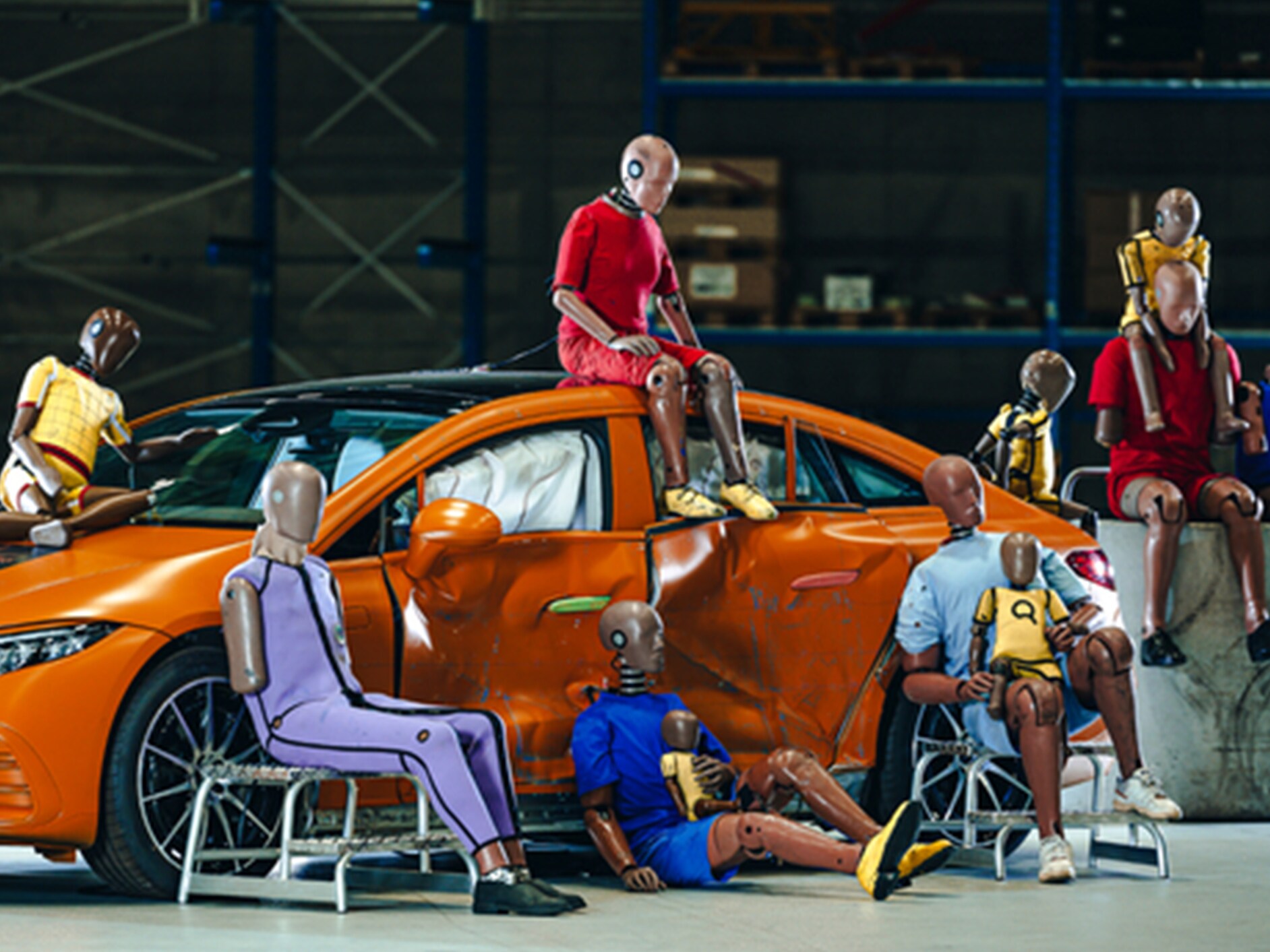Multiple crash test dummies sitting on and arround a Mercedes-Benz car.