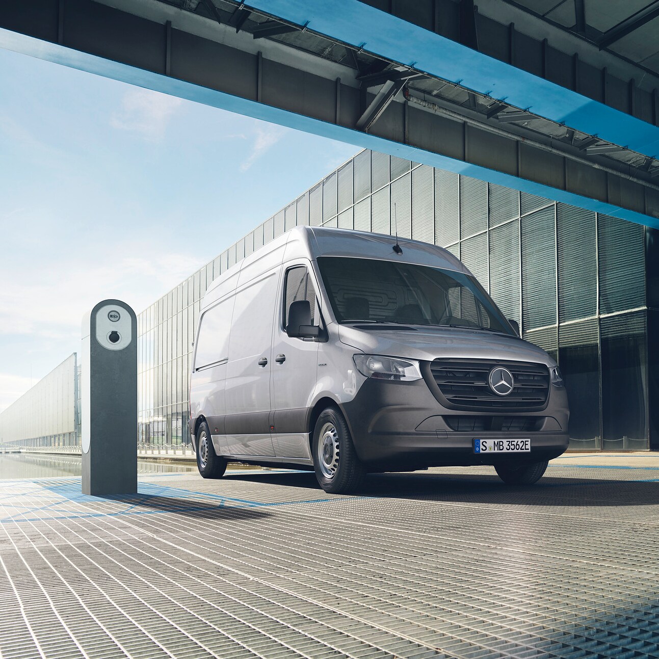 The Mercedes-Benz Vito Tourer is parked in front of a glass building.
