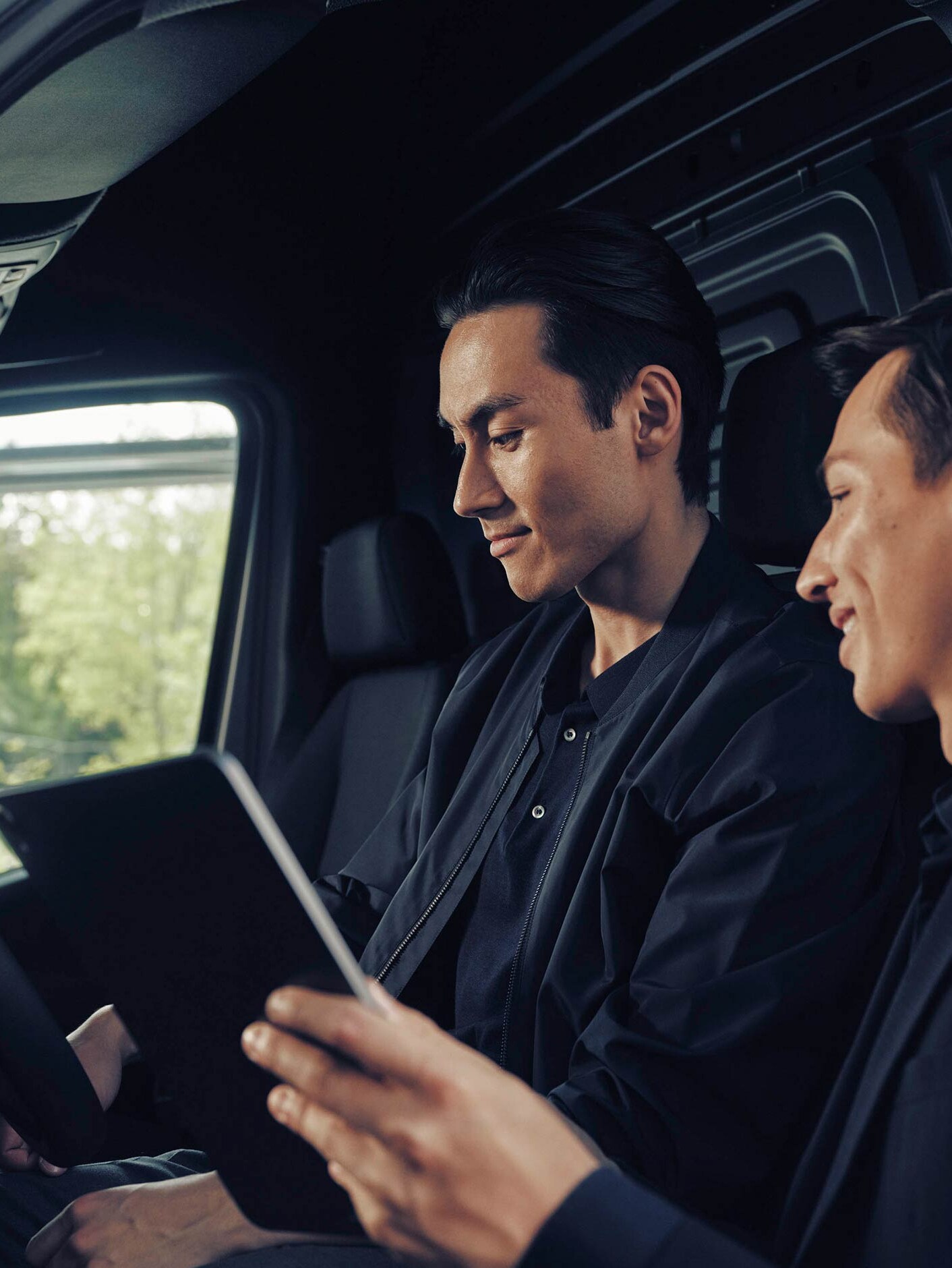 A man in conversation with a dealer in a Mercedes-Benz eSprinter van