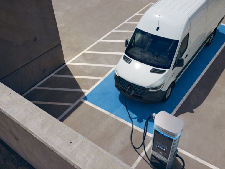 The Mercedes-Benz eSprinter Panel Van at a charging station.