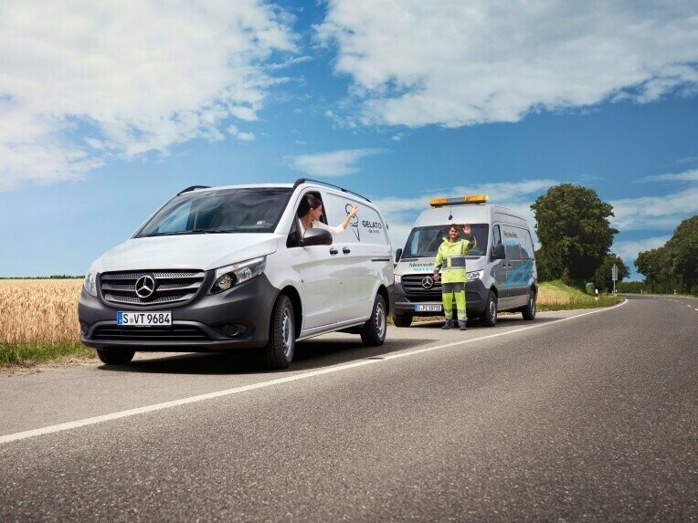 A Mercedes-Benz van and a Mercedes-Benz Service24h vehicle at the roadside.