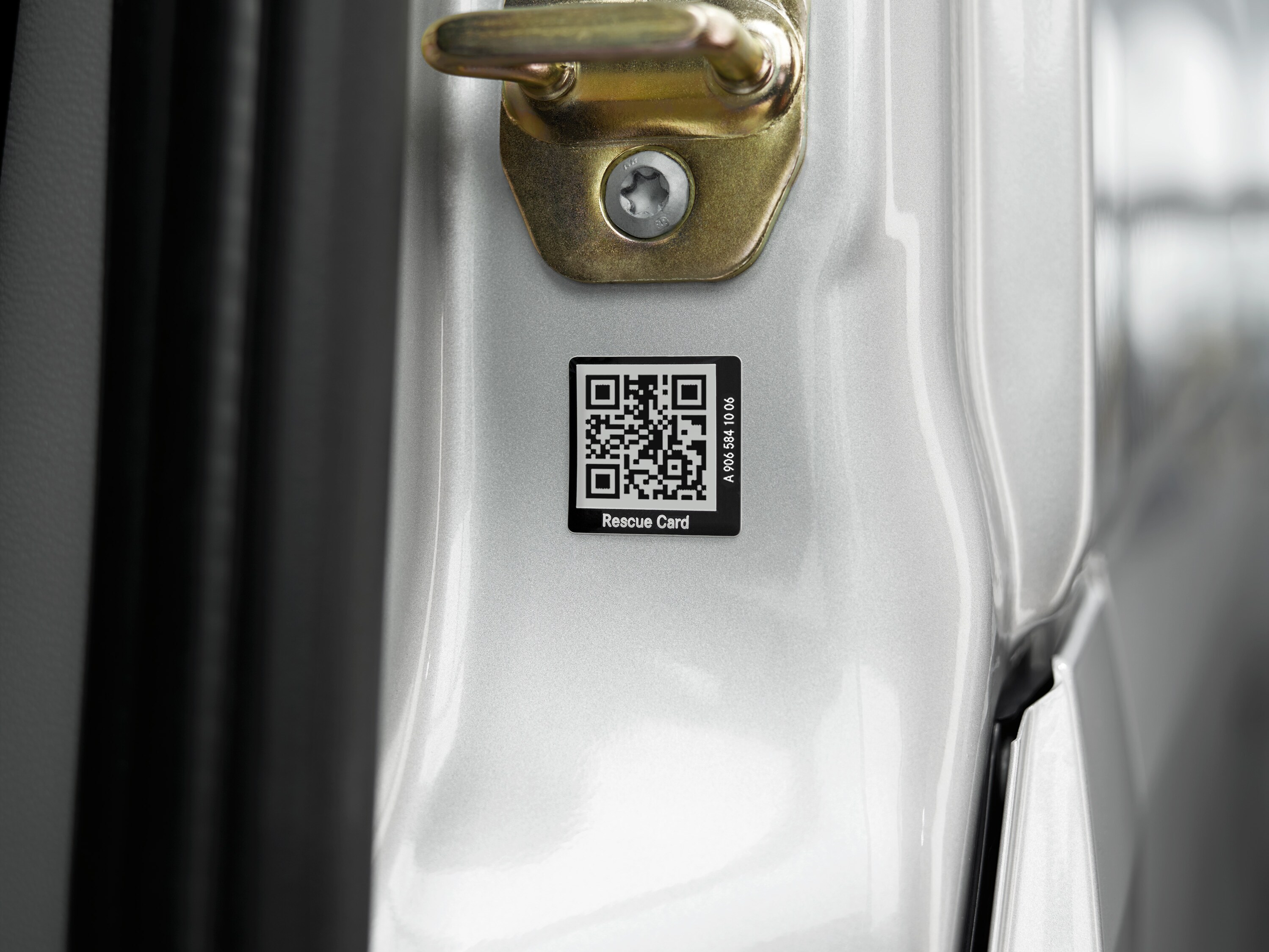 Close-up of a rescue card sticker with QR code on the vehicle door for rapid assistance in an emergency.