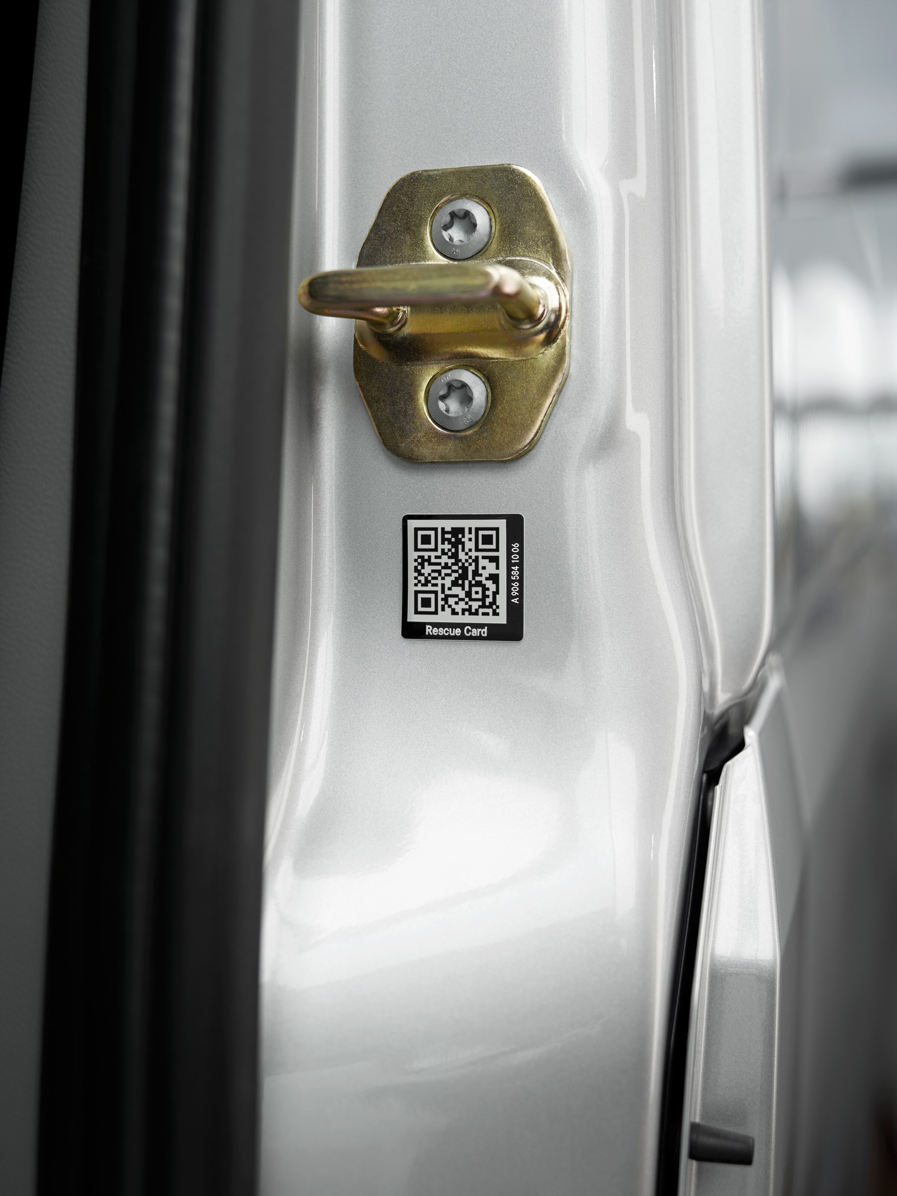 Close-up of a rescue card sticker with QR code on the vehicle door for rapid assistance in an emergency.