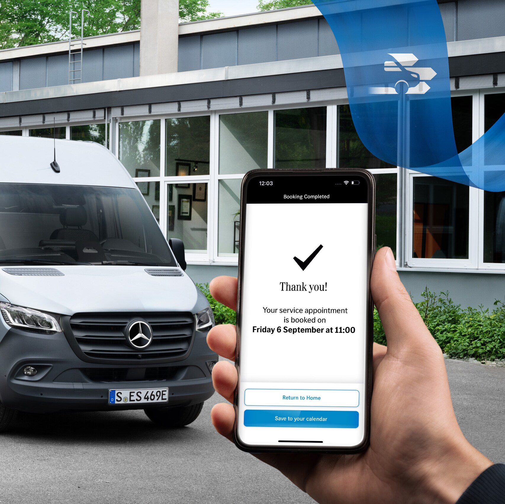 A grey Mercedes-Benz Sprinter van in front of an office build with a hand holding a smartphone in the foreground.