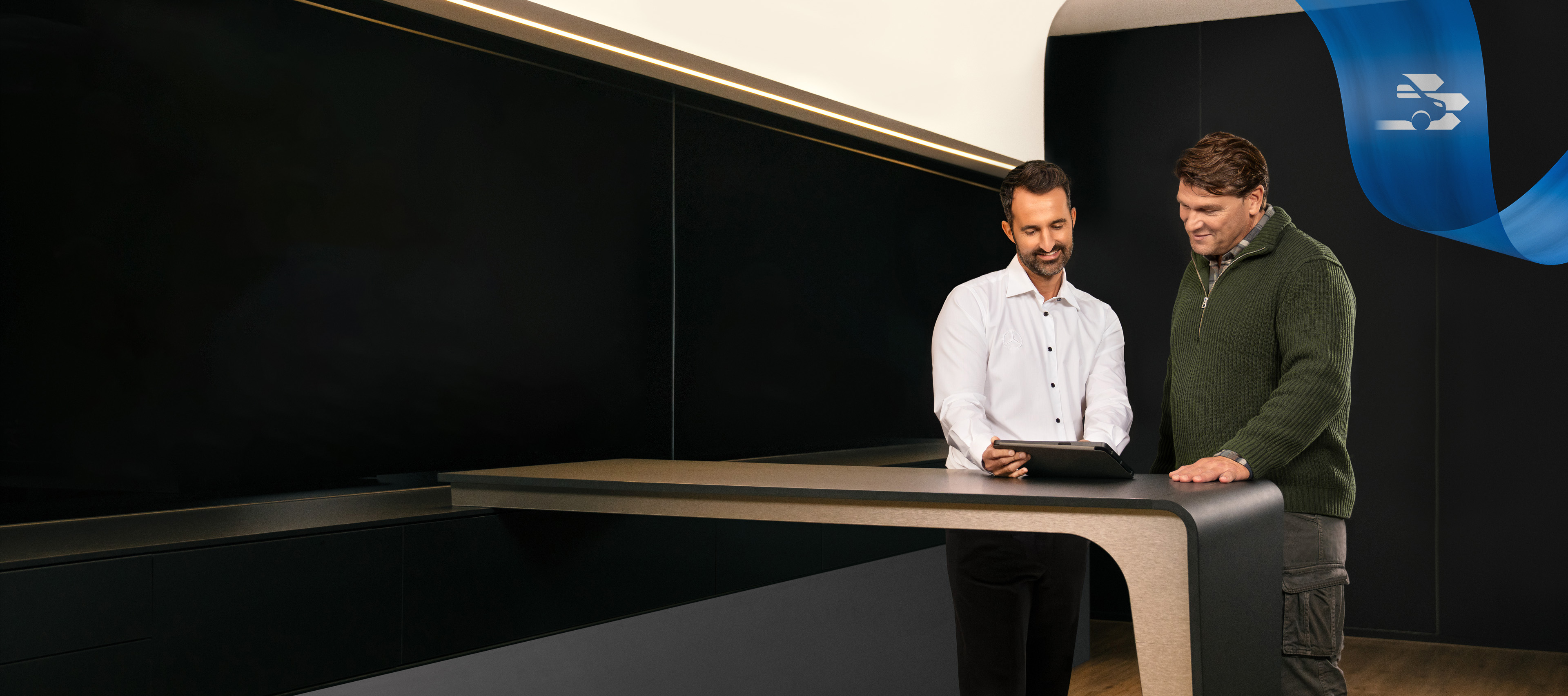 Mercedes-Benz | Convenience | Service Partner Two Men standing in a Mercedes-Benz Service Partner office, discussing something seen on a Tablet