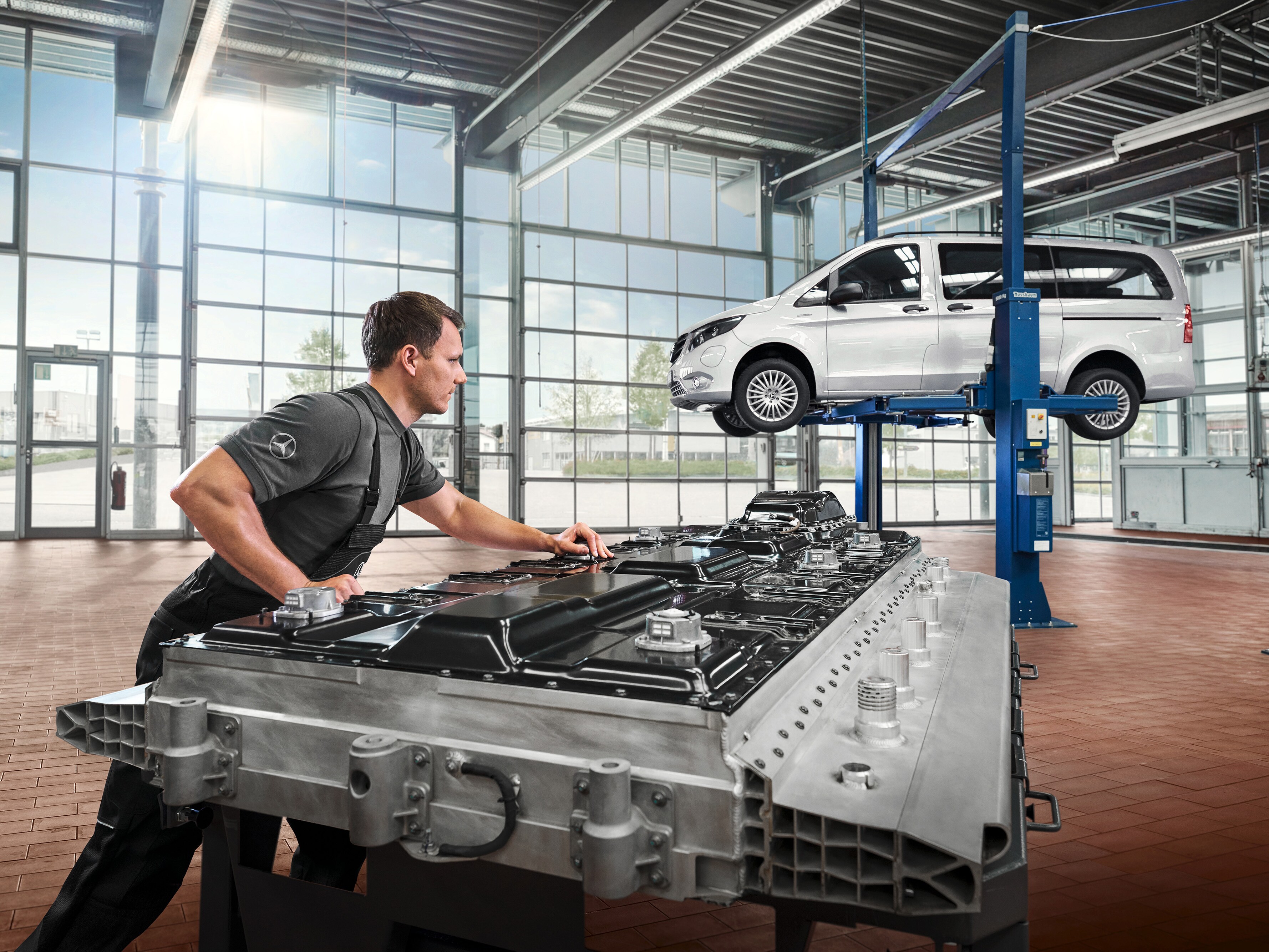 A technician checks battery modules in the workshop.